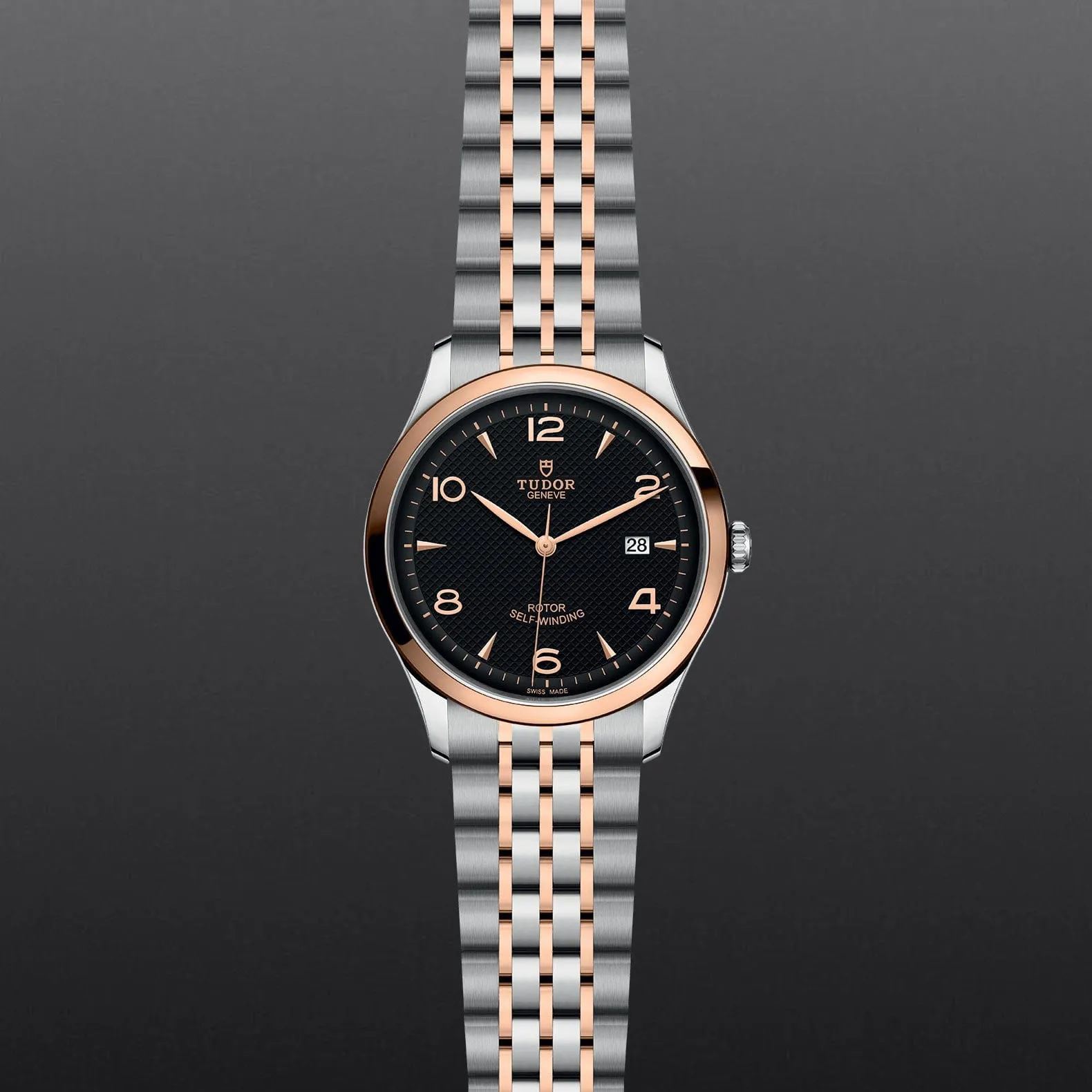 M91651-0003 Tudor 1926 41 mm 18 kt Rose Gold And Stainless Steel Automatic Watch. The Watch Has A Smooth Gold  Bezel, Steel Case, Black Dial With Arabic Numbers, Date At 3 O'clock And A Rose Gold And Steel Bracelet With A Safety Clasp.
