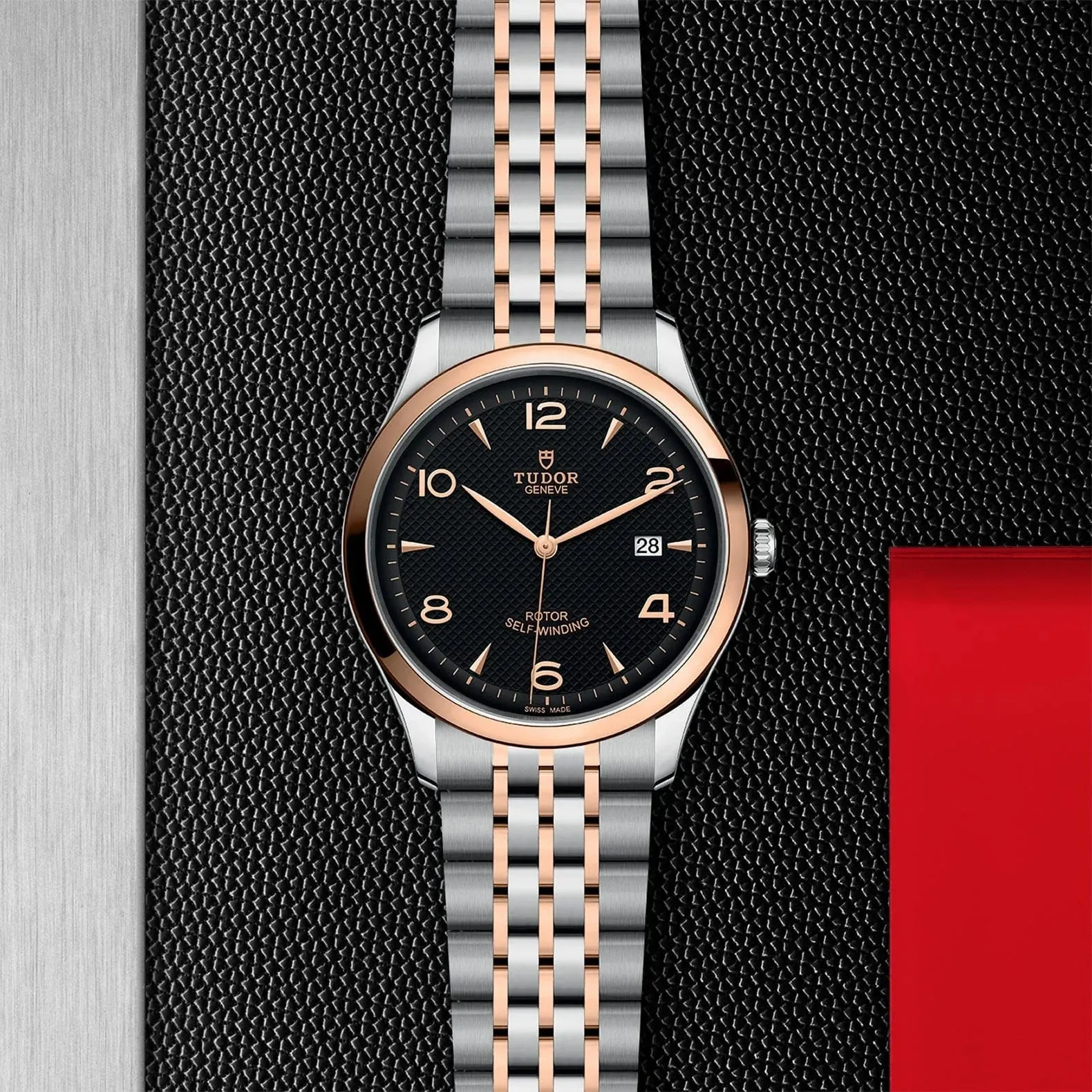 M91651-0003 Tudor 1926 41 mm 18 kt Rose Gold And Stainless Steel Automatic Watch. The Watch Has A Smooth Gold  Bezel, Steel Case, Black Dial With Arabic Numbers, Date At 3 O'clock And A Rose Gold And Steel Bracelet With A Safety Clasp.