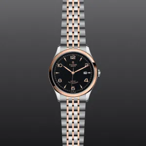 M91651-0003 Tudor 1926 41 mm 18 kt Rose Gold And Stainless Steel Automatic Watch. The Watch Has A Smooth Gold  Bezel, Steel Case, Black Dial With Arabic Numbers, Date At 3 O'clock And A Rose Gold And Steel Bracelet With A Safety Clasp.